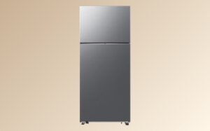 Silver refrigerator freezer displayed against a beige background, showcasing its sleek design and modern features.