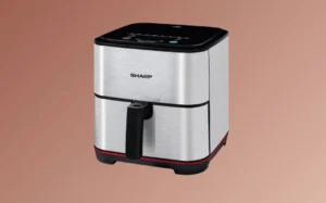 A stainless steel air fryer positioned on a brown background, showcasing its sleek design and modern features.