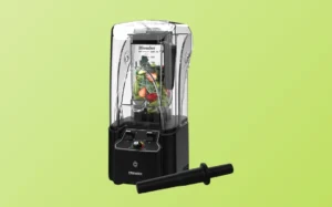 A commercial blender with a black lid set against a vibrant green background.