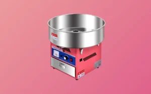 A small metal cotton candy machine set against a vibrant red background.