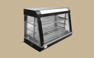 A commercial display case with a glass top showcasing various food warmers inside.